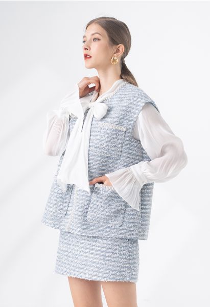 Chaqueta sin mangas de tweed con bolsillo y borde nacarado en azul