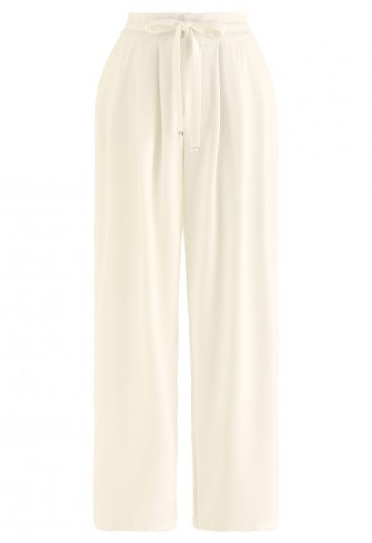 Pantalones de pernera ancha con cordón en la cintura con detalle plisado en color crema