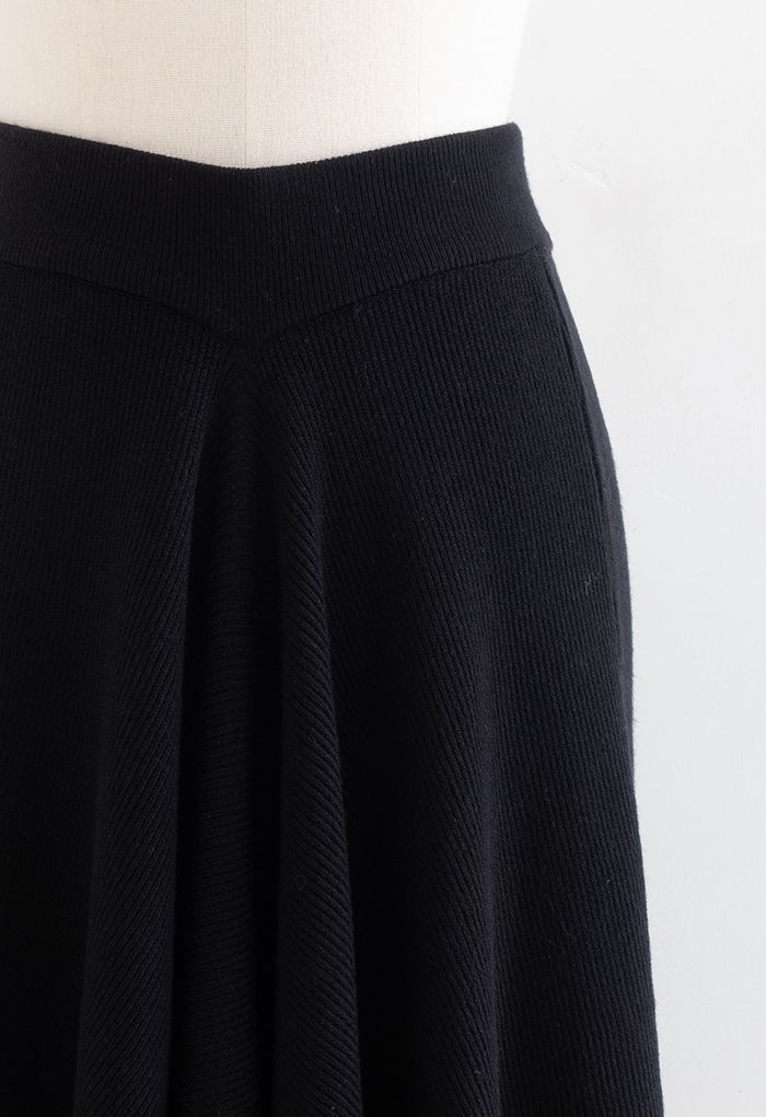 Falda midi de punto con dobladillo asimétrico en negro de Sencillez