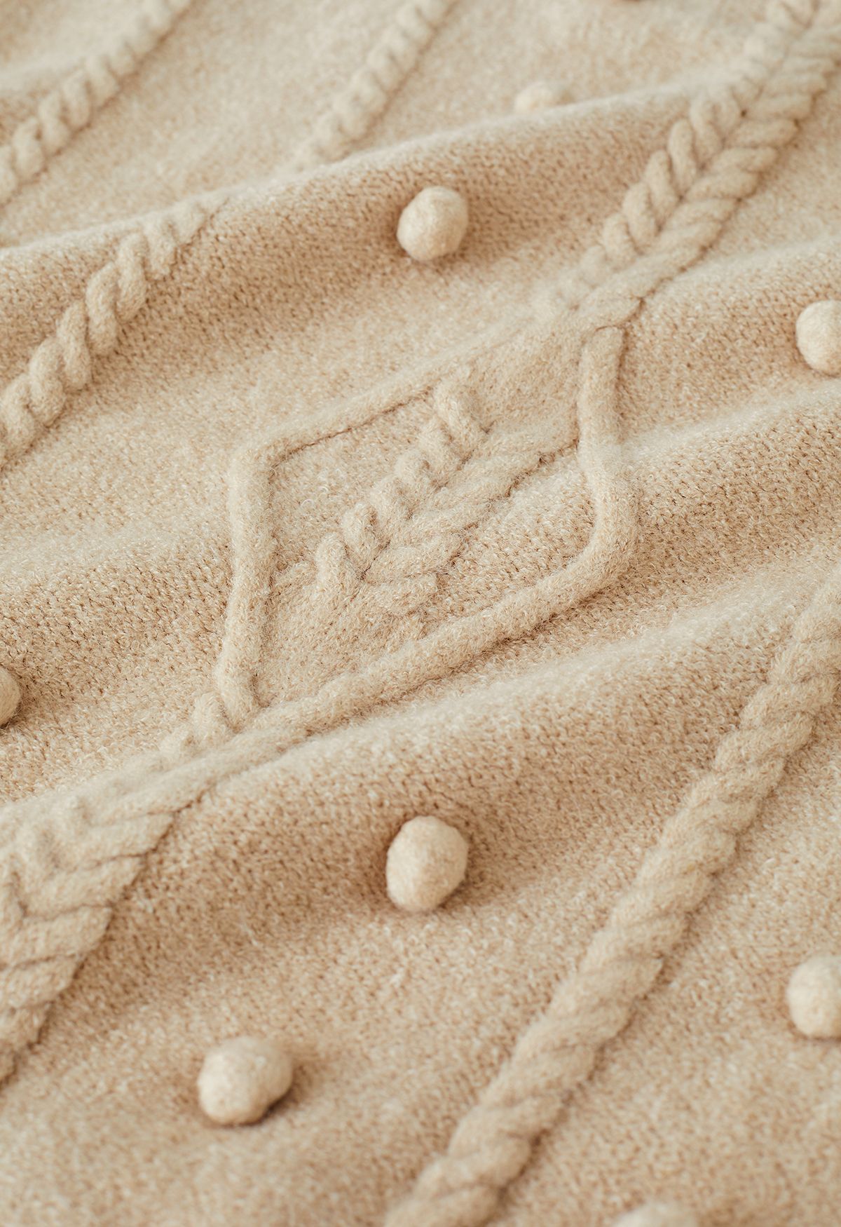 Suéter de punto trenzado con ribete de pompones en tostado