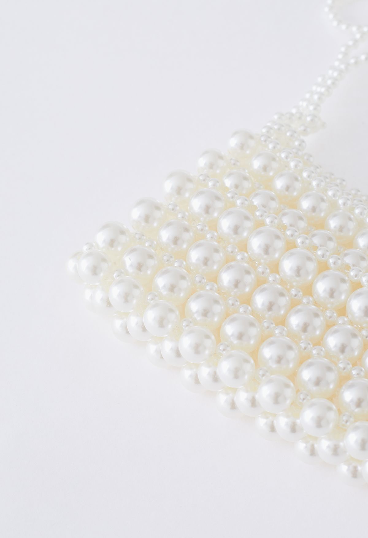 Minibolso trenzado con cadena floral de perlas completas