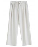 Pantalones con detalles plisados en la cintura con cordón en marfil